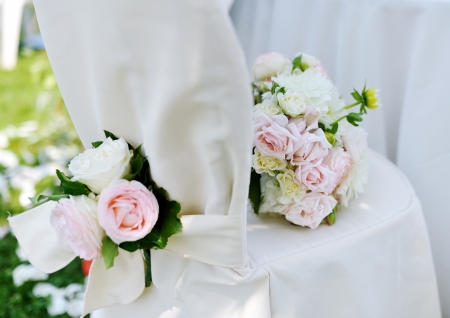 Beautiful wedding bouquet on a white decorated chairの写真素材