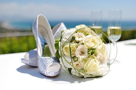 beautiful wedding bouquet of roses and wedding shoesの写真素材