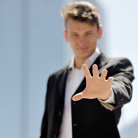 hand close-up of a young smiling businessman - successful and positive thinking conceptの写真素材