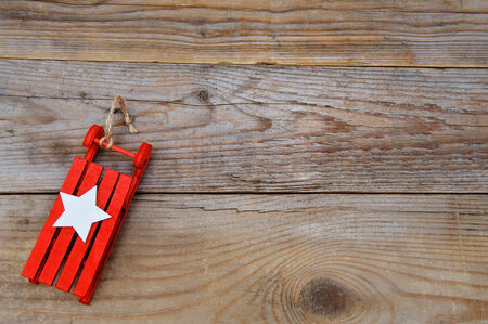 Christmas background - red sleigh on woodの写真素材