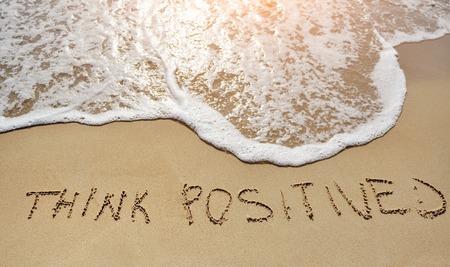 think positive written on the sand beach - positive thinking conceptの写真素材