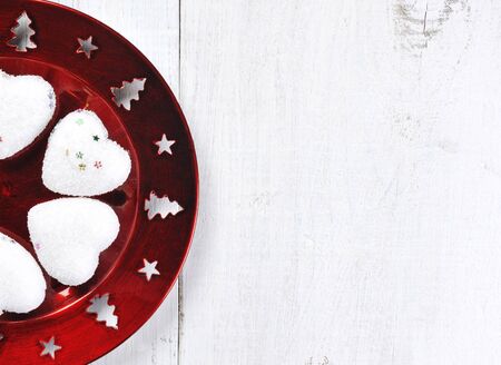 christmas red plate decoration on wooden backgroundの写真素材