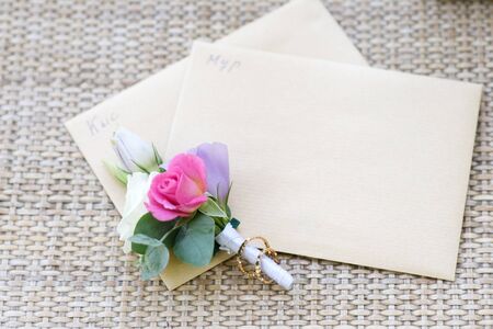 Groom boutonniere and wedding rings