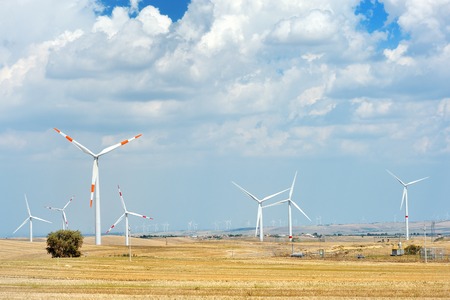 Wind generator turbine in a field - sustainable energy conceptの写真素材