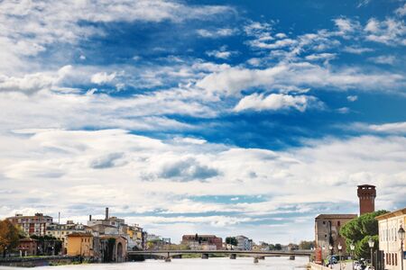 Pisa, Tuscany, Italy - Scenic view of Arno river, blue sky and cloudsの写真素材