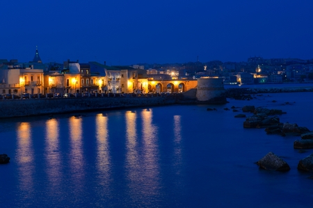 Ortigia island coastline scenic view at night blue hour, Syracuse, Sicily, Italy, Europeの写真素材