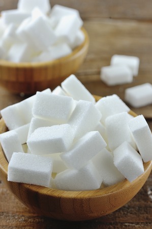 Sweet sugar cubes in a wooden bowlの写真素材