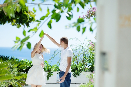 Young loving couple dancing on the terrace on the background of the sea Positano, Italy - love conceptの写真素材