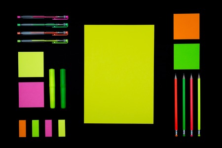 Neon paper and stationery on blackの写真素材