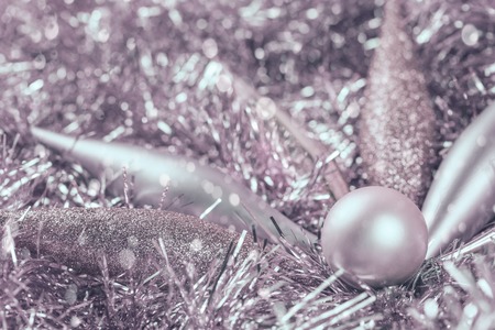 Pastel pink Christmas decorations on tinsel in monochrome color with copy spaceの写真素材