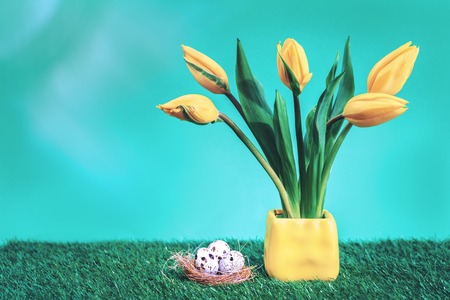 Easter background yellow tulips and eggs in a nest, Easter concept with copy spaceの写真素材