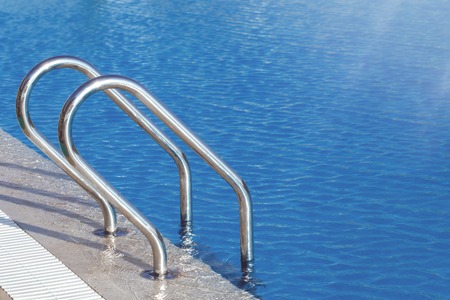 Swimming pool water with blue perforated platic lane marker with copy space and selective focusの写真素材