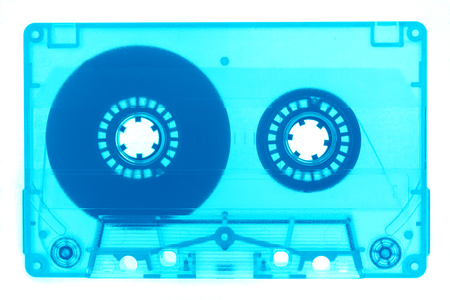 Trendy reviving retro audio cassette tape transparent neon blue isolated on white full frame. Analogue music hipster trendの写真素材