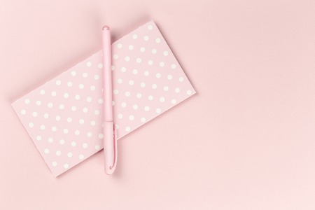 Stylish feminine accessories, ornaments, gifts, sweets and purse items in blue pastel colors on rose pink background and polka dot. Copy space, mock up. Women's day or bloggers concept. Flat layの写真素材
