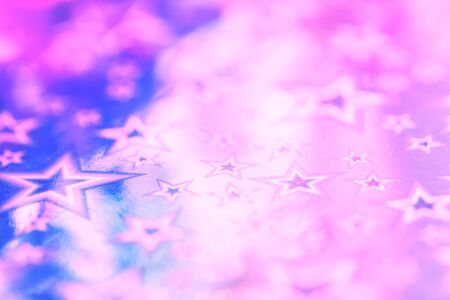 Sparkling golden glitter abstract background purple blue desaturated color, fluid defocused, macro. Foil silver stars. party festive celebration backgroundの写真素材