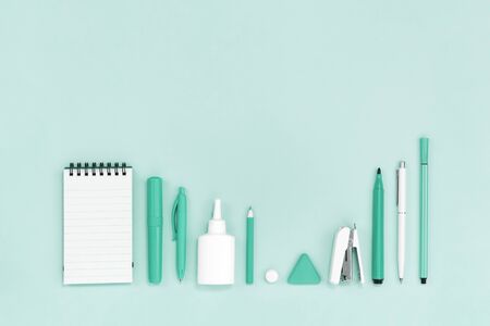 Trending pastel green monochrome shades office or school stationery flat lay. Education or crafts...