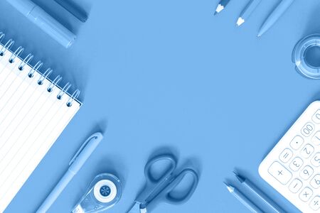 Assorted office and school white and blue stationery on pastel trendy background as border. Flat lay...