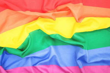 LGBTQ pride creased rainbow flag slightly faded. top view banner or backdropの写真素材