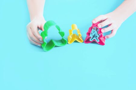 Happy family concept cut outs in hands of a child. Mother, father, son, daughter and pregnancy top view with copy spaceの写真素材