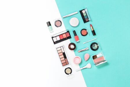 Feminine makeup aqua mente and pink palette accessories with nail polish manicure tools on white and blue background. Flat lay pattern with copy space, beauty and cosmetics conceptの写真素材