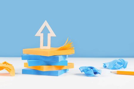 Business or education growth development and success concept banner. Arrow on tower of sticky notes...