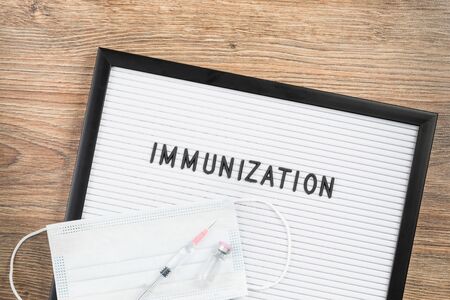 immunization term and syringe. medical concept. Text on white letter board. Minimal medical concept. vaccine research or administration. Pro and contraの写真素材