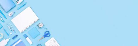 Assorted office and school white and blue stationery on pastel background as border. Flat lay...