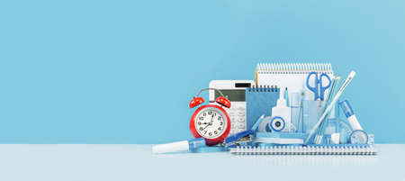 Group of office supplies and school blue stationery and red alarm clock on desk. Banner for back to...