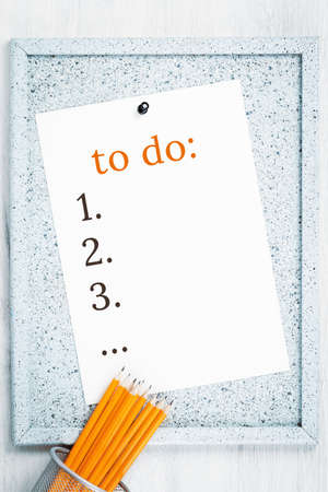 Blank To Do List on a cork notice board with yellow pencils. Plan checklist and resolutions,...