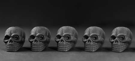 Halloween party set up props. Several black sculls on black. Monochrome. Death symbol. Fear and...