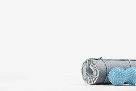 Rolled blue yoga mat and massage ball. Gender neutral fitness and exercise concept accessories with copy space. Active lifestyle. Workout at home or gym, sports club posterの写真素材