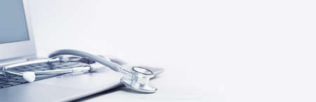 Stethoscope on a laptop. Virus season, pandemic. Remote medicine or elearning and telemedicine and consultation advice. Copy space. Medical network or contact us bannerの写真素材