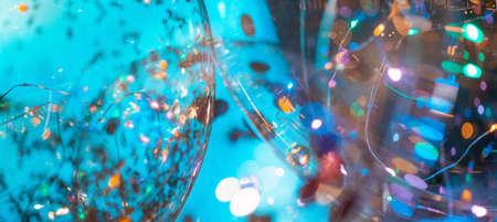 Blue balloons with natural bokeh texture and defocused sparkling lights. Teal and orange blur background with twinkling lights. Festive multi-colored overlay colors. Birthday banner copy spaceの写真素材