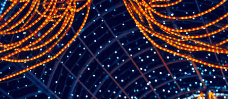Colorful background with natural bokeh texture and defocused sparkling lights. Teal blue and orange blur background with twinkling Christmas lights. Festive multi-colored overlay colors. copy spaceの写真素材