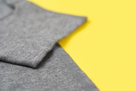 Gray comfortable and cozy jersey Knitwear Fabric Texture closeup on yellow 2021 color trend. copy spaceの写真素材