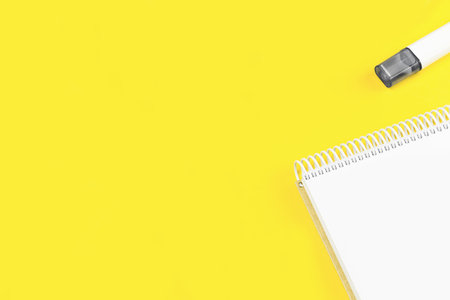 Open notepad on trendy yellow illuminating background. Minimal with copy space for back to school education test and craft or message concept. Storytelling mockup web bannerの写真素材
