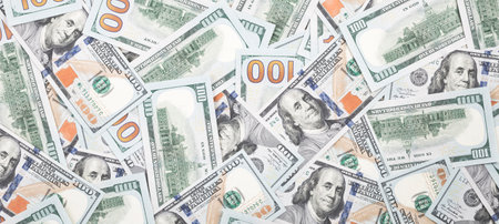 Lots of hundred dollar bills. cash money background. Top view banner