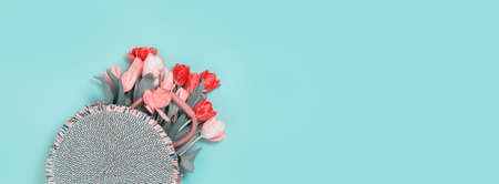 bouquet of fresh red pink tulips in a wicker bag on pastel teal. Flat lay copy space, Birthday gift....