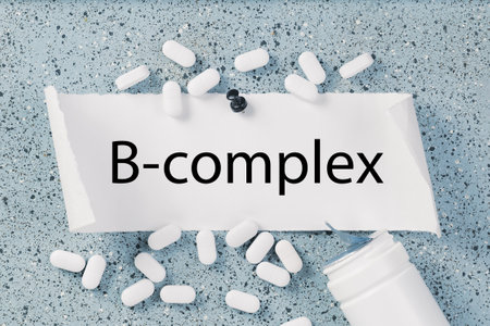 Vitamin B complex text with white capsules or pills on notice board. Medicine and wellbeing health