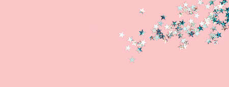 Scattered pink holographic glitter confetti star  on pinkの写真素材