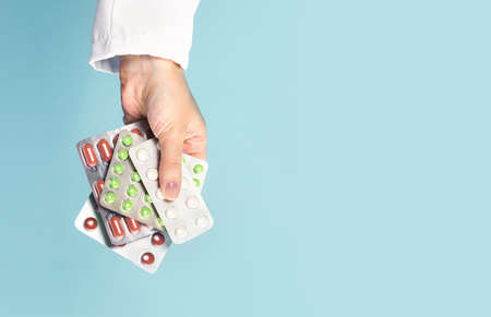 Female caucasian doctor nurse hand with pills or prescription drugs. Medicine and pharmacy. General practitioner or pcp family doctor appointment. Medical concept. Pharmacy. Banner copy spaceの写真素材