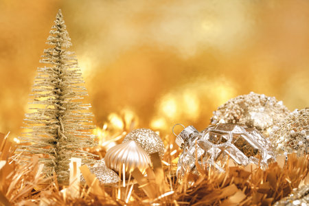 Merry Christmas and Happy New Year rich golden and crystal festive ornaments baubles tinsel glitter and Christmas tree. Party decor greeting card. Monochrome banner. Side view copy spaceの写真素材