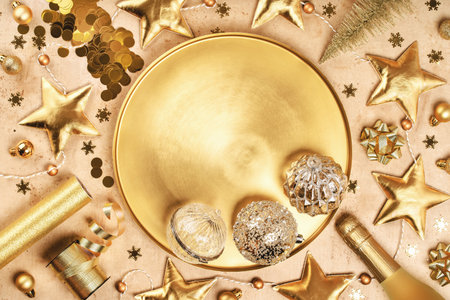 Merry Christmas and Happy New Year rich golden tray with crystal festive ornaments baubles tinsel stars glitter and sparkling wine. Party decor frame with copy space. Monochrome background. Top viewの写真素材