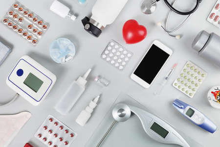 Medical flat lay. Red heart with stethoscope water bottle tape measure tablets. Blood pressure meter. Healthy lifestyle with cardio condition and obesity or weight management. Copy spaceの写真素材