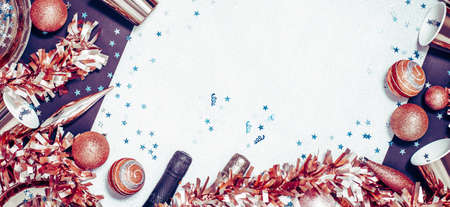 Golden red Merry Christmas and New Year tinsel and baubles border with Sparkling wine bottles and...