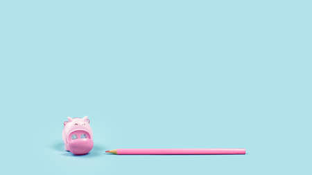Pink pencil and piggy shaped sharpener on plain baby blue background. Minimal. Copy spaceの写真素材