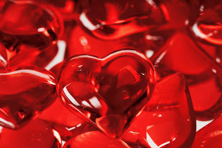 Valentines day concept many little red glass hearts closeup