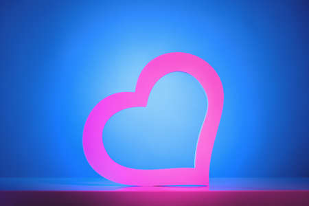 abstract ultraviolet background with pink neon heart frameの写真素材