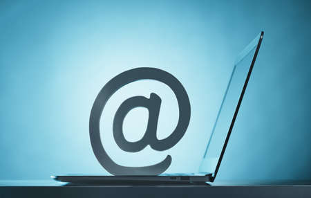At symbol on top of open laptop. Email. Mailboxの写真素材