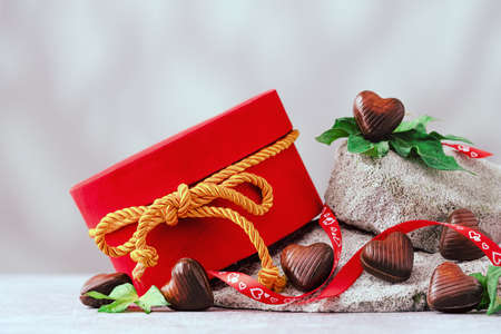 Several chocolate hearts on gray stones bannerの写真素材